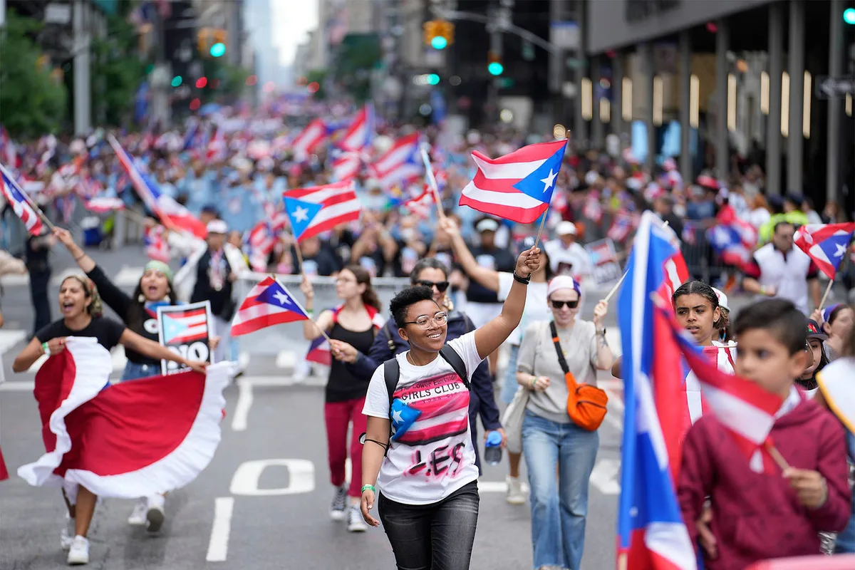 Crowd waving Puerto Rican flags at the Puerto Rican Day Parade in New York City