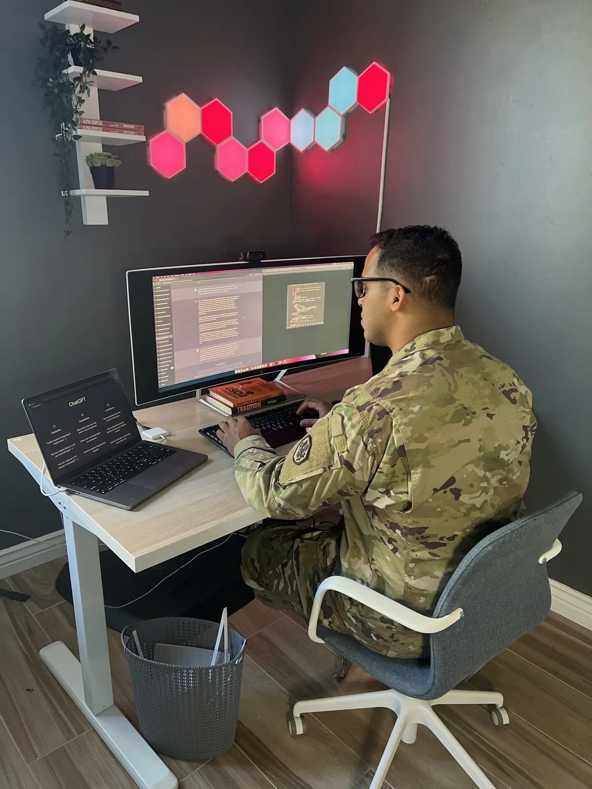 Robert Solano in Army uniform at his desk researching artificial intelligence